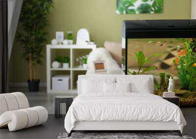 Beautiful aquarium on table in room Wall mural