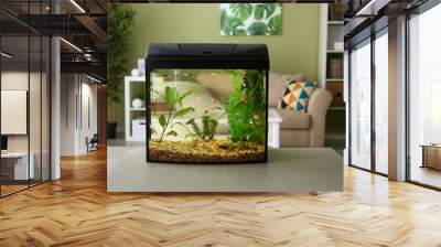 Beautiful aquarium on table in room Wall mural