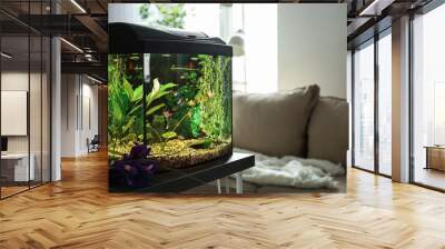 Beautiful aquarium on table in room Wall mural