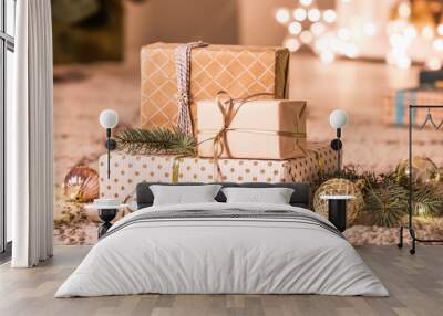 Beautiful Christmas gift boxes on floor in room Wall mural