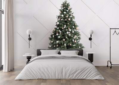 Beautiful Christmas tree with gift boxes near light wall Wall mural