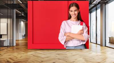 Beautiful female student on color background Wall mural