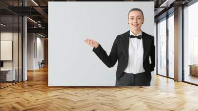 Beautiful female waiter on grey background Wall mural