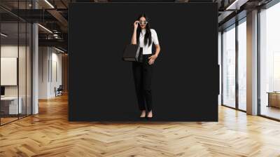 Beautiful stylish woman with shopping bags on dark background. Black Friday Sale Wall mural