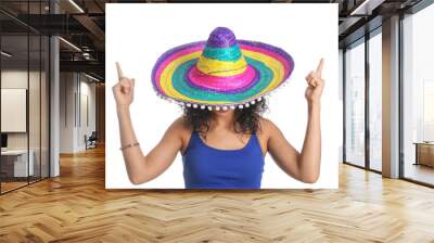 Beautiful woman in sombrero hat pointing at something on white background Wall mural