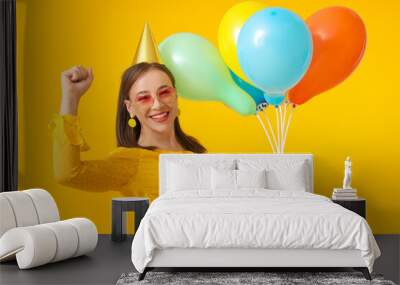 Beautiful woman with balloons on color background Wall mural