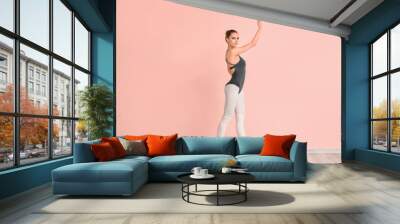 Beautiful young ballerina near color wall Wall mural