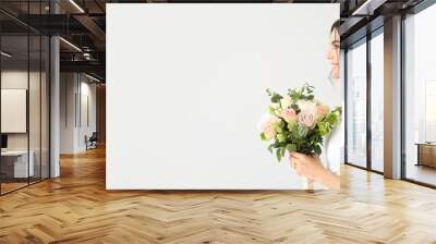 Beautiful young bride with bouquet of flowers on light background with space for text Wall mural