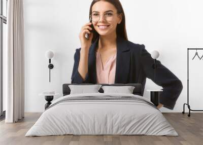 Beautiful young businesswoman talking by phone on white background Wall mural