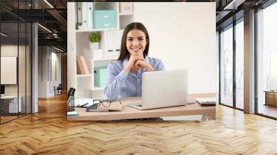 Beautiful young businesswoman working in office Wall mural