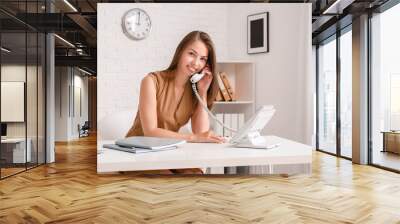 Beautiful young businesswoman working in office Wall mural