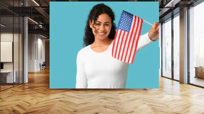 Beautiful young happy African-American woman with USA flag on blue background Wall mural