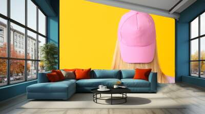 Beautiful young woman in stylish cap on color background Wall mural