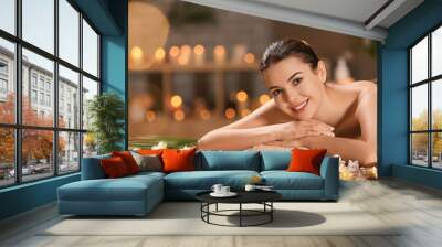 Beautiful young woman relaxing in spa salon Wall mural