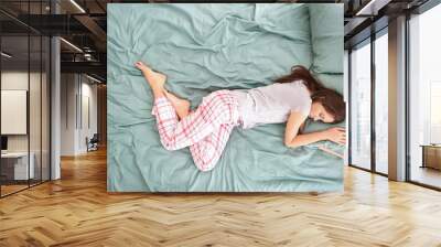 Beautiful young woman sleeping in her bed at home Wall mural