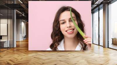 Beautiful young woman with aloe vera on pink background Wall mural