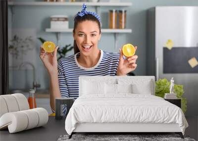 Beautiful young woman with fresh products in kitchen Wall mural