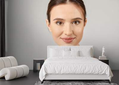 Beautiful young woman with healthy skin on light background Wall mural