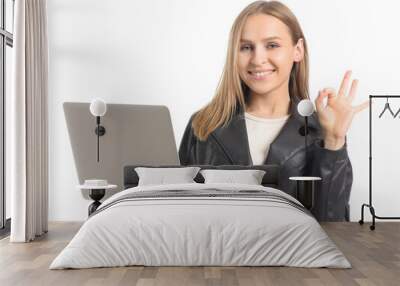 Beautiful young woman with laptop showing OK gesture on white background Wall mural