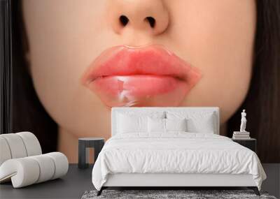 Beautiful young woman with lip mask, closeup Wall mural