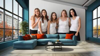 Beautiful young women on light background. Concept of body positivity Wall mural