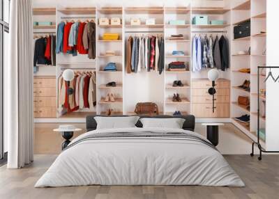 Big wardrobe with clothes in dressing room Wall mural