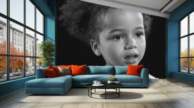 Black and white portrait of little African-American girl on dark background Wall mural