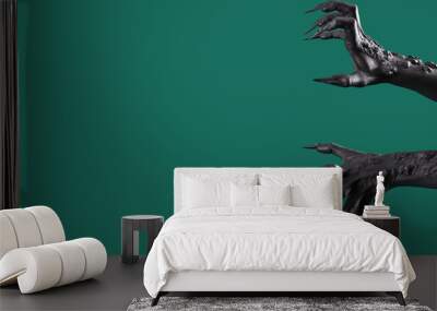 Black hands of witch with claws on green background. Halloween celebration Wall mural