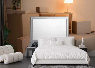 Blank laptop on moving box in room, closeup Wall mural