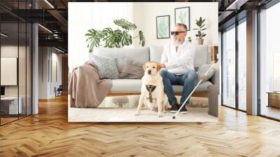 Blind mature man with guide dog at home Wall mural