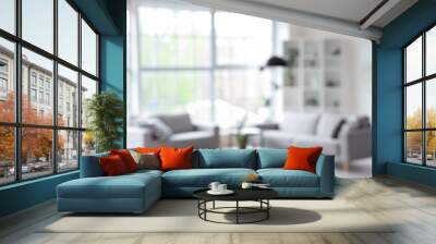 Blurred interior of light living room with grey sofas, coffee table and big window Wall mural