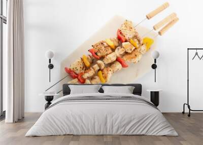 Board of grilled chicken skewers with vegetables isolated on white background Wall mural