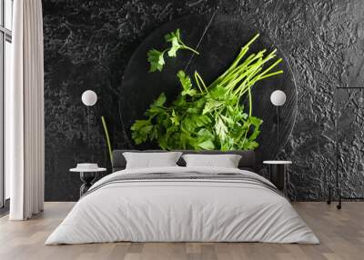 Board with fresh parsley on dark background Wall mural