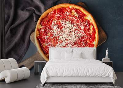 Board with tasty Chicago-style pizza on dark background Wall mural