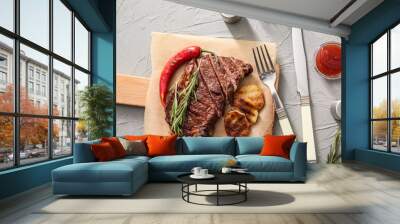 Board with tasty grilled meat, vegetables, spices and herbs on light table Wall mural