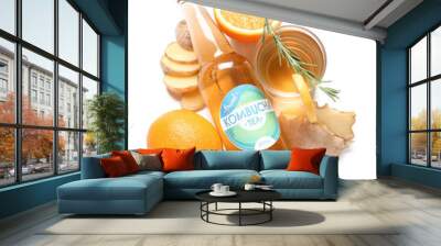 Bottle and glass of tasty kombucha tea with orange and ginger on white background Wall mural