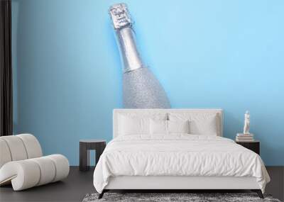 Bottle of champagne on color background. New Year celebration Wall mural