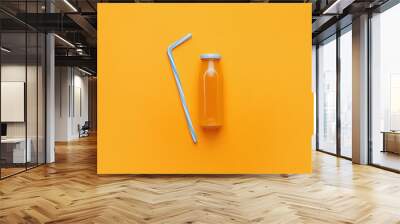 Bottle of juice on color background Wall mural