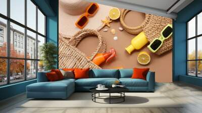 Bottles with sunscreen cream, sunglasses and bags on brown background Wall mural