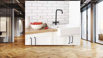 Bowl and basket with tasty strawberries near sink in kitchen Wall mural