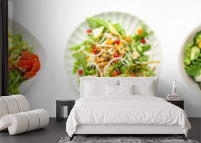 Bowl of fresh salad with vegetables on white background Wall mural