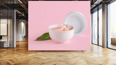 Bowl of natural body scrub and lid on pink background Wall mural