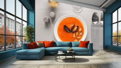 Bowl of tasty Cacciucco soup and wine glasses on table Wall mural