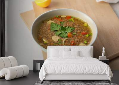 Bowl of tasty lentil soup on table Wall mural