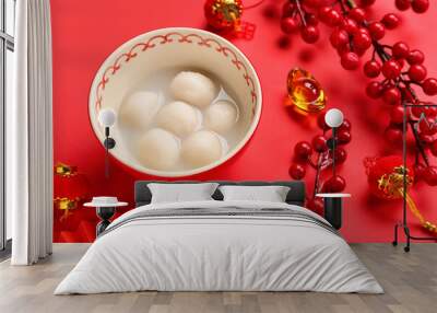 Bowl of tasty tangyuan and Chinese decor on red background, closeup. Dongzhi Festival Wall mural