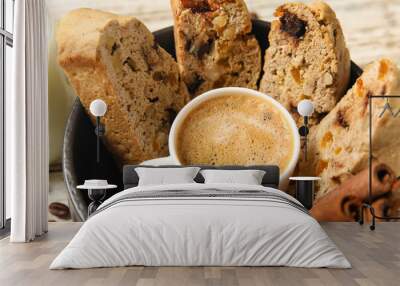 Bowl with cup of coffee, delicious biscotti cookies and cinnamon on white wooden background Wall mural