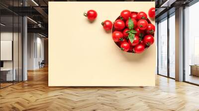 Bowl with fresh cherry tomatoes and basil on orange background Wall mural