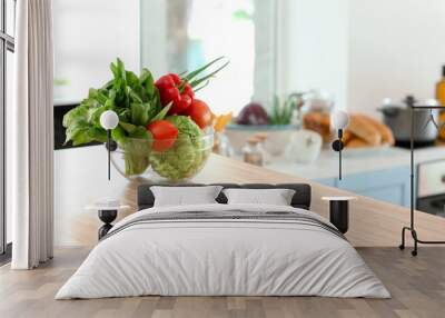 Bowl with fresh vegetables on table in kitchen Wall mural