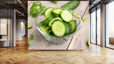 bowl with pieces of fresh cucumber on light wooden background Wall mural