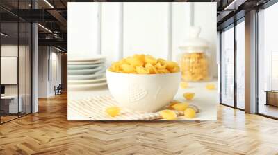 Bowl with raw conchiglie pasta on light background Wall mural